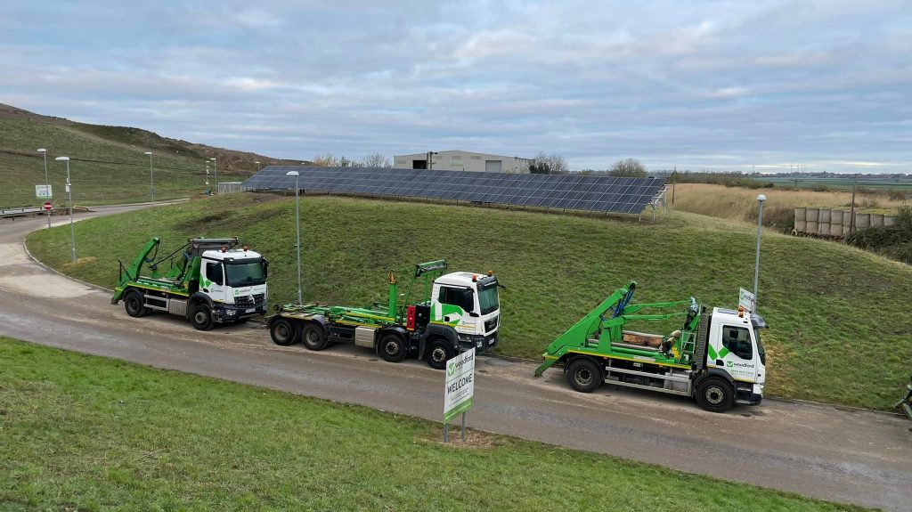 Woodford Recycling vehicles next to solar energy panels