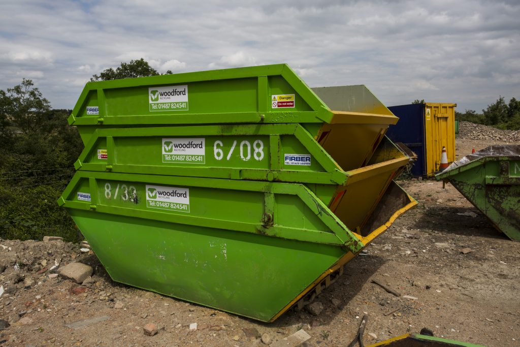 Three green skips stacked on top of each other | Woodford Recycling