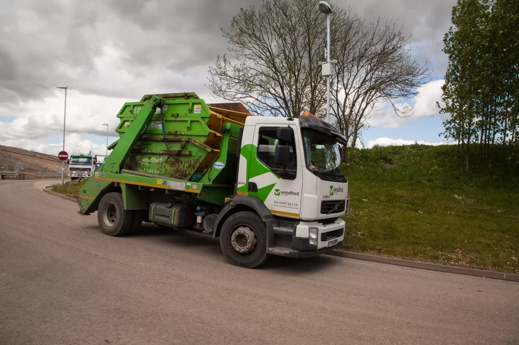 a skip hire lorry moving garden waste | Woodford Recycling