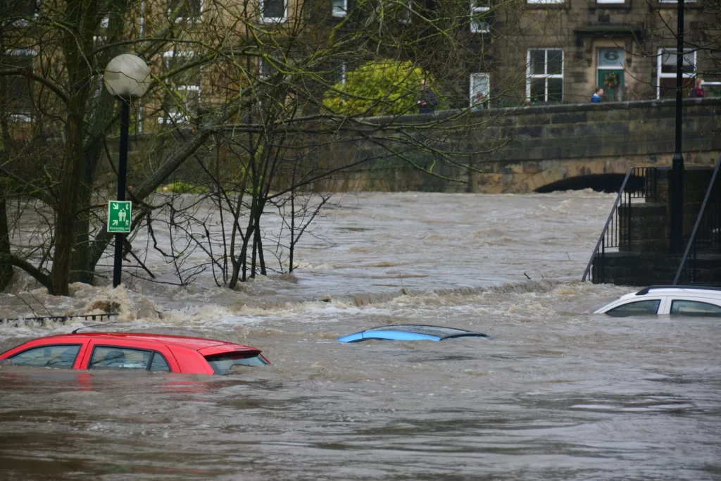 a flooded street with cars under water | Woodford Recycling